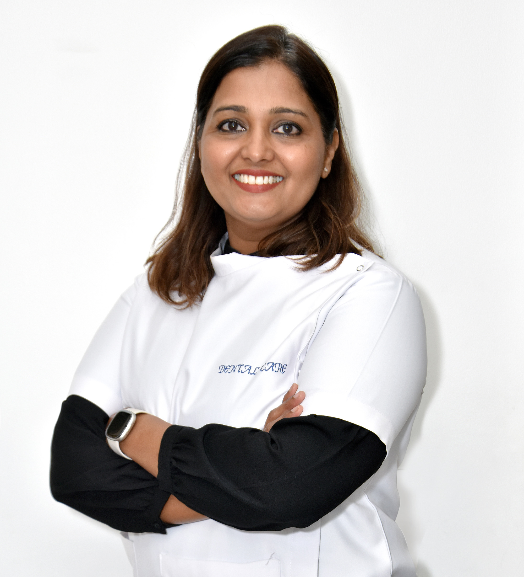 Professional dentist in protective gear working on patient with dental equipment